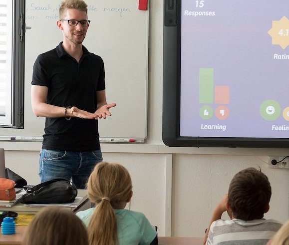 Teacher and Students in a classroom - Stare Academy Employment
